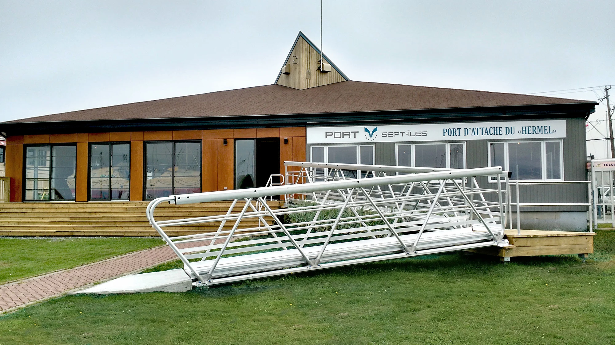 MakeABridge aluminum modular pedestrian bridges by MAADI Group installed at the Port of Sept-Îles, providing durable, corrosion-free wheelchair access to the administration building.