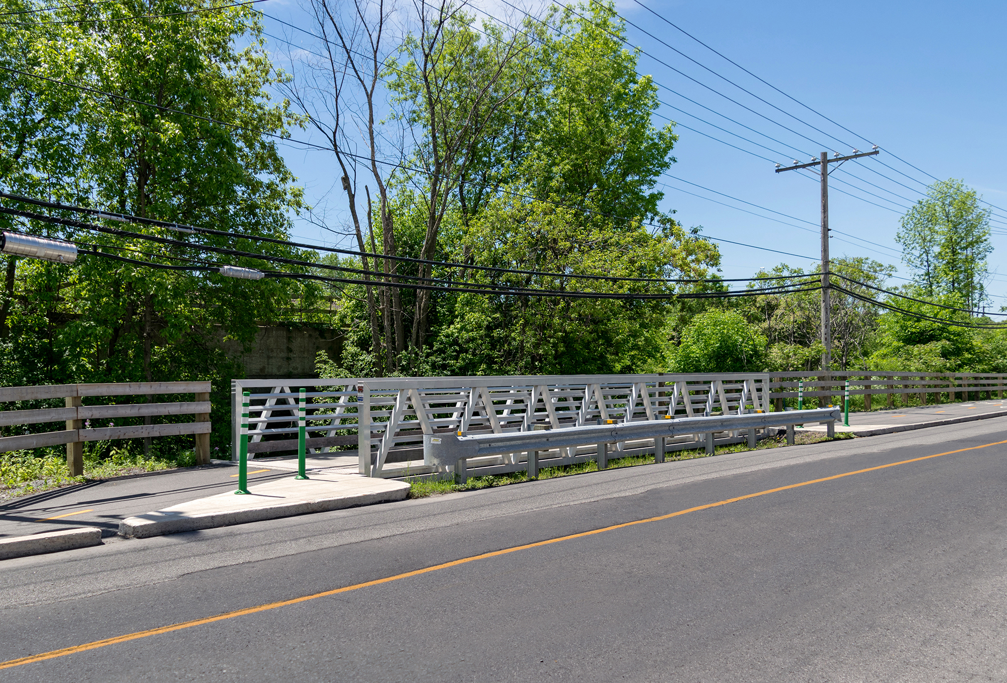 Custom aluminum bridge used to extend roadway for bike path in Quebec, Canada