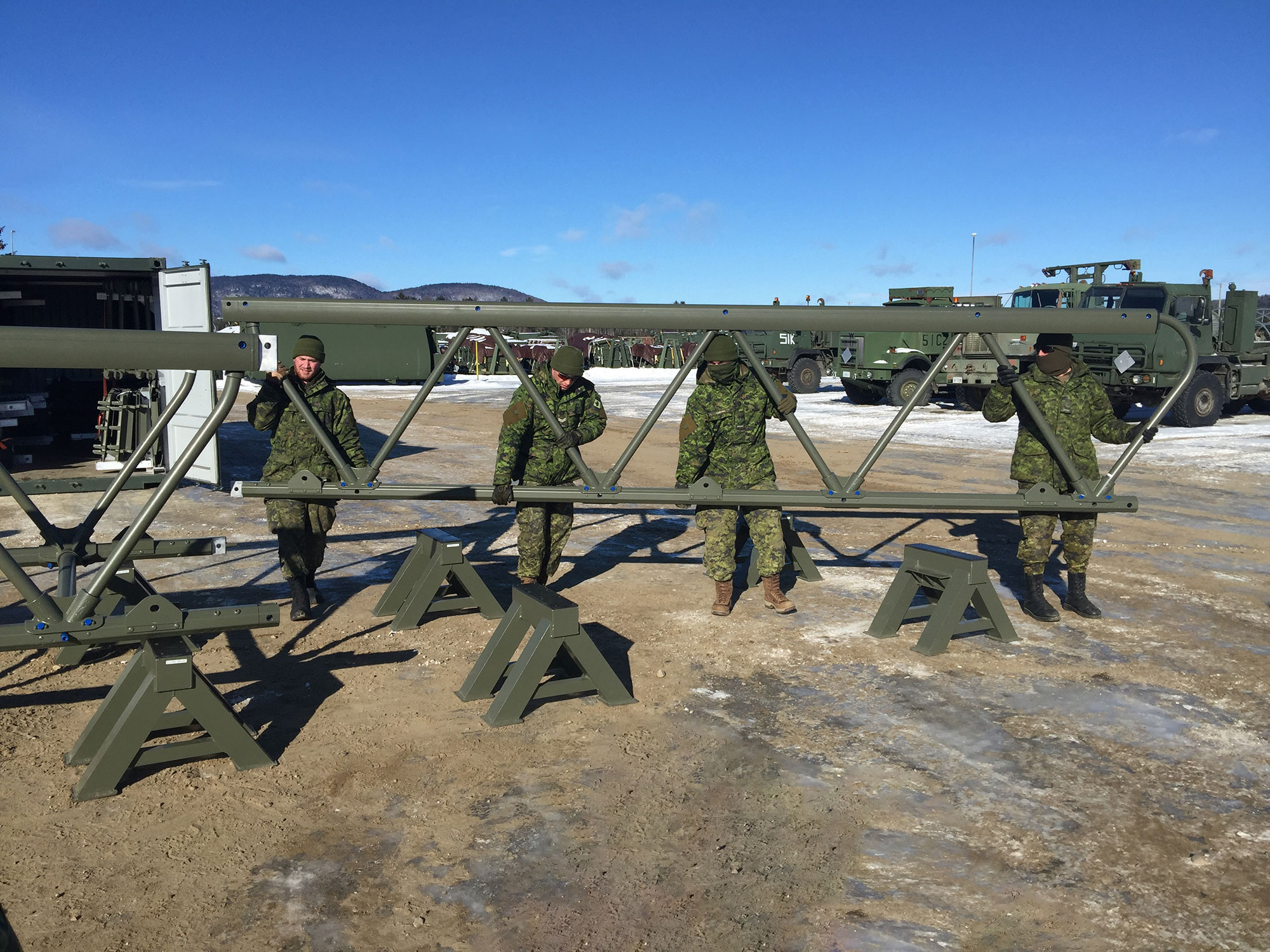 Four soldiers assembling LVTB-1811 lightweight aluminum bridge