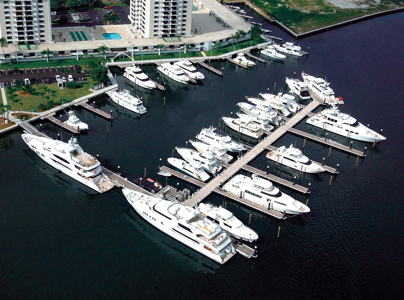 Small and large watercraft moored on modular floating docks in Florida