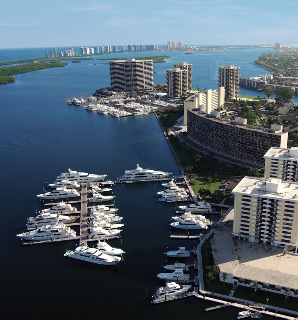 Aluminum marina with yachts moored on developed Florida coast.
