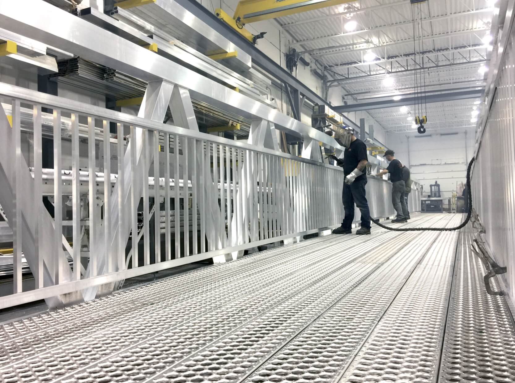 MAADI Group employees manufacturing an aluminum bridge