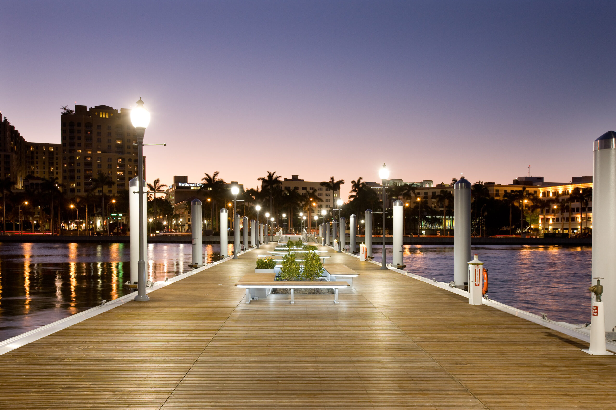 Public pier with wood decking, benches and custom landscaping features in Florida