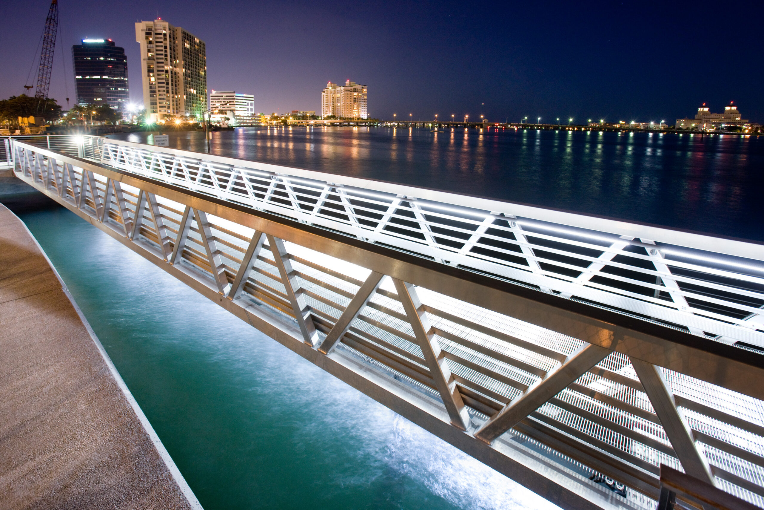 Illuminated custom aluminum gangway on urban public pier in Florida