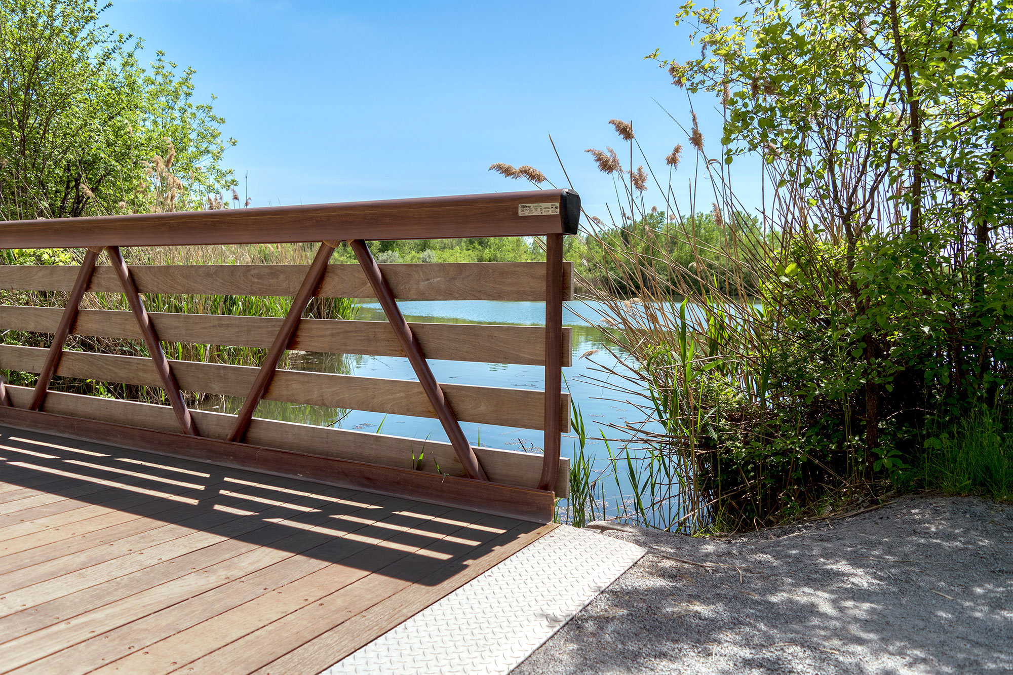 Weld-free aluminum pedestrian bridge with hardwood decking and faux-wood guardrail finish