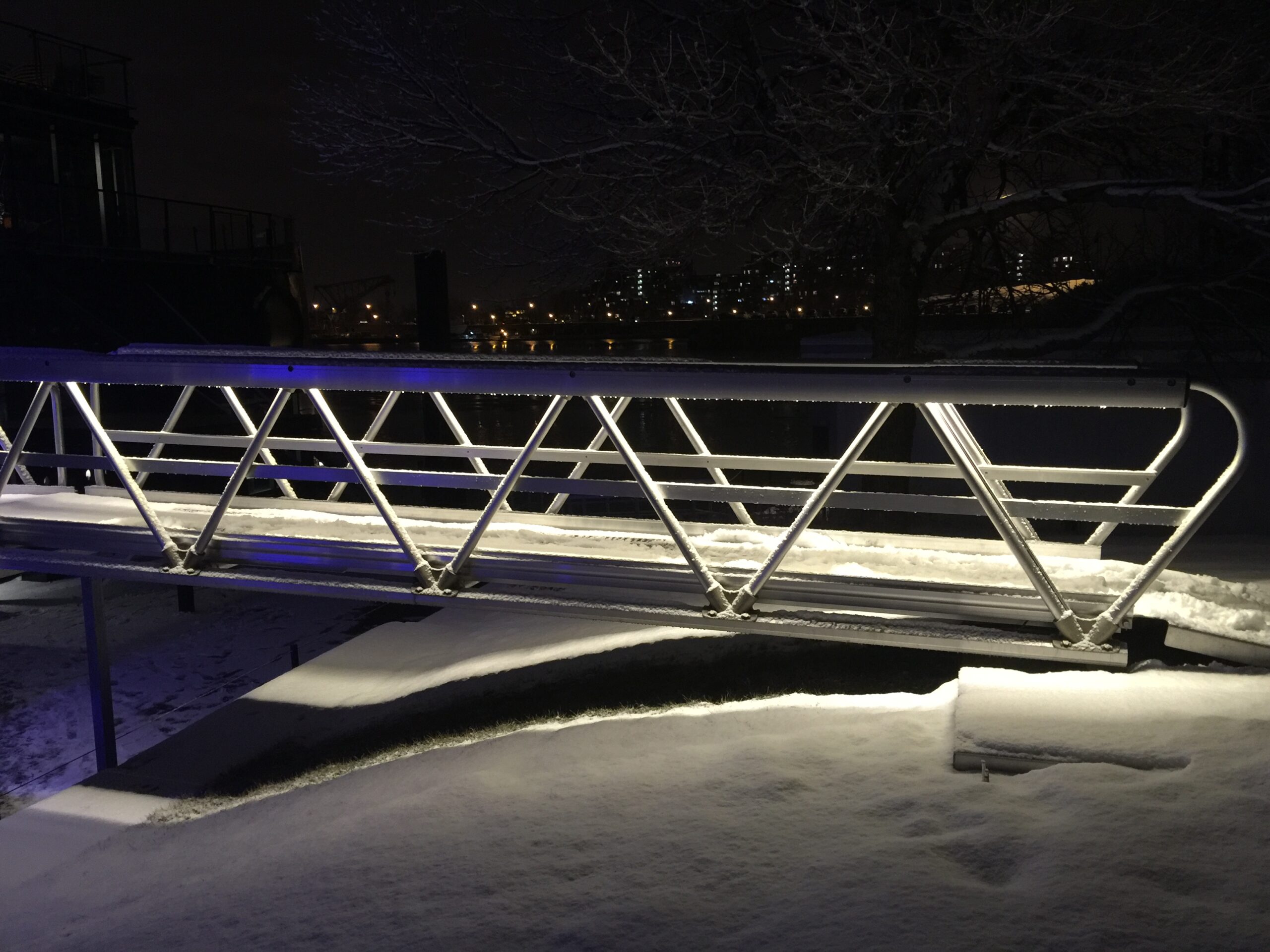 Aluminum gangway in snowy urban setting with built-in lighting