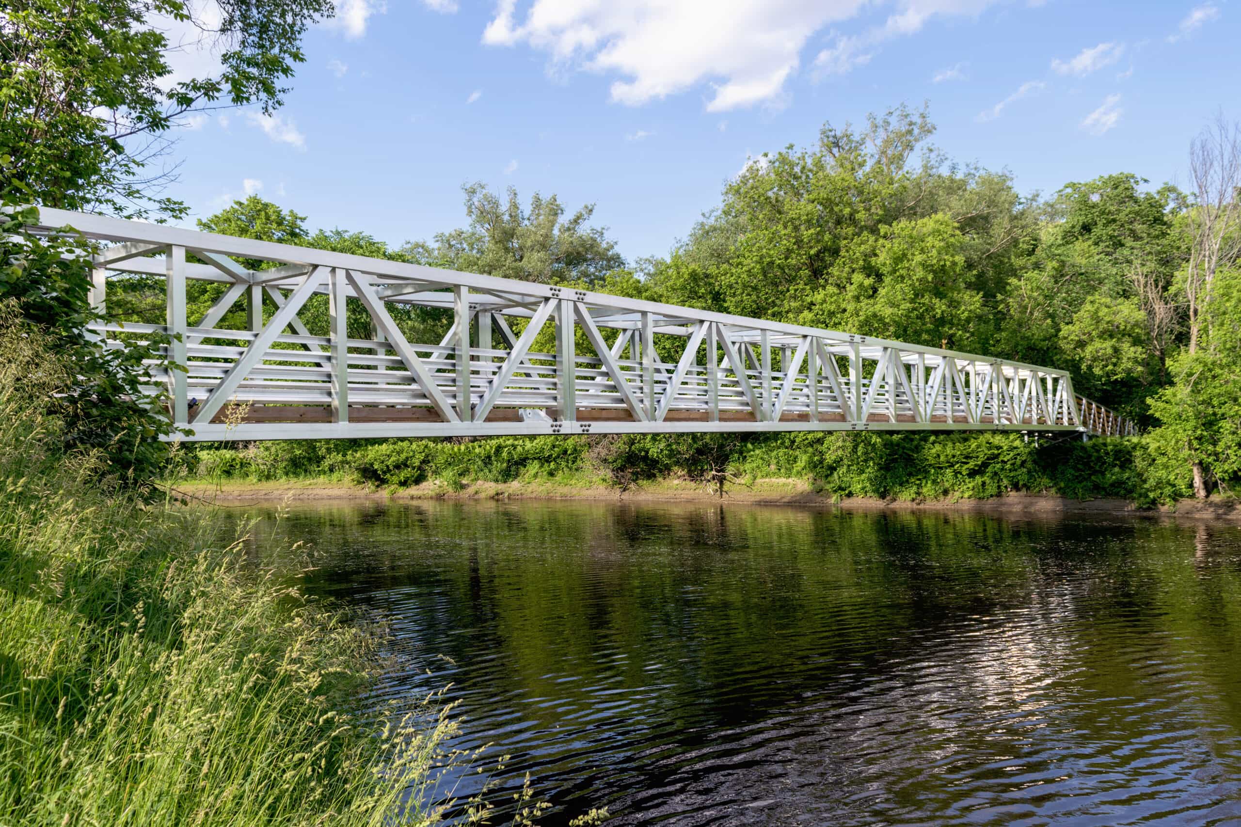 Custom pedestrian bridge crossing over water in Quebec, Canada