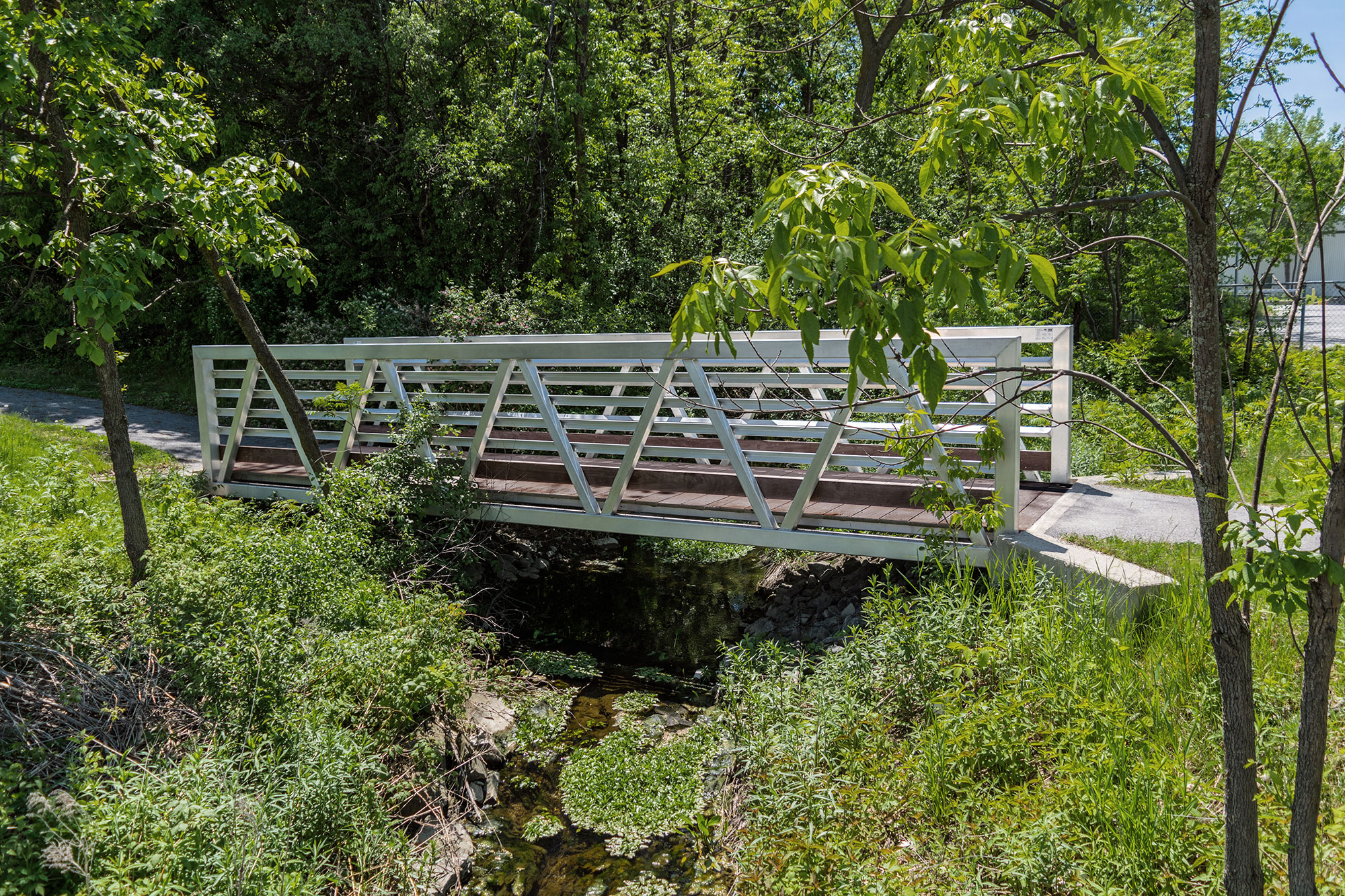 Custom aluminum footbridge for ATVs crossing over creek in Quebec, Canada