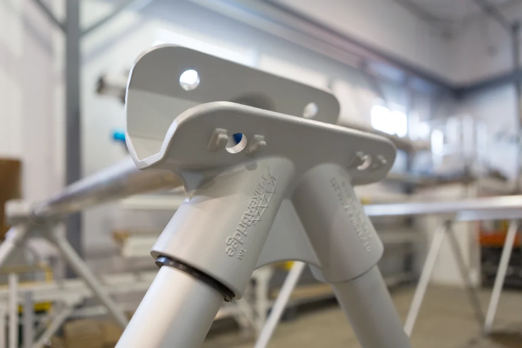 Aluminum tripod node from MAADI Group’s MakeABridge® system showing tapered struts, composite sleeves, and conical sockets for fast modular bridge assembly