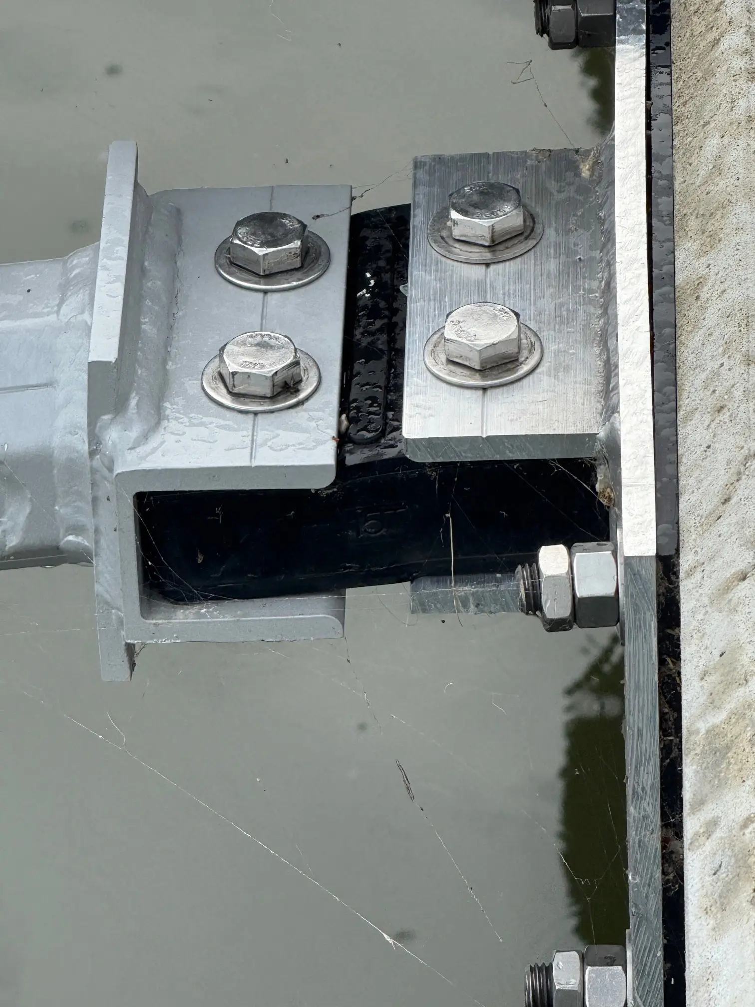 Flexible dock connector with precisely sized internal reinforcement for enhanced durability in severe storm conditions.