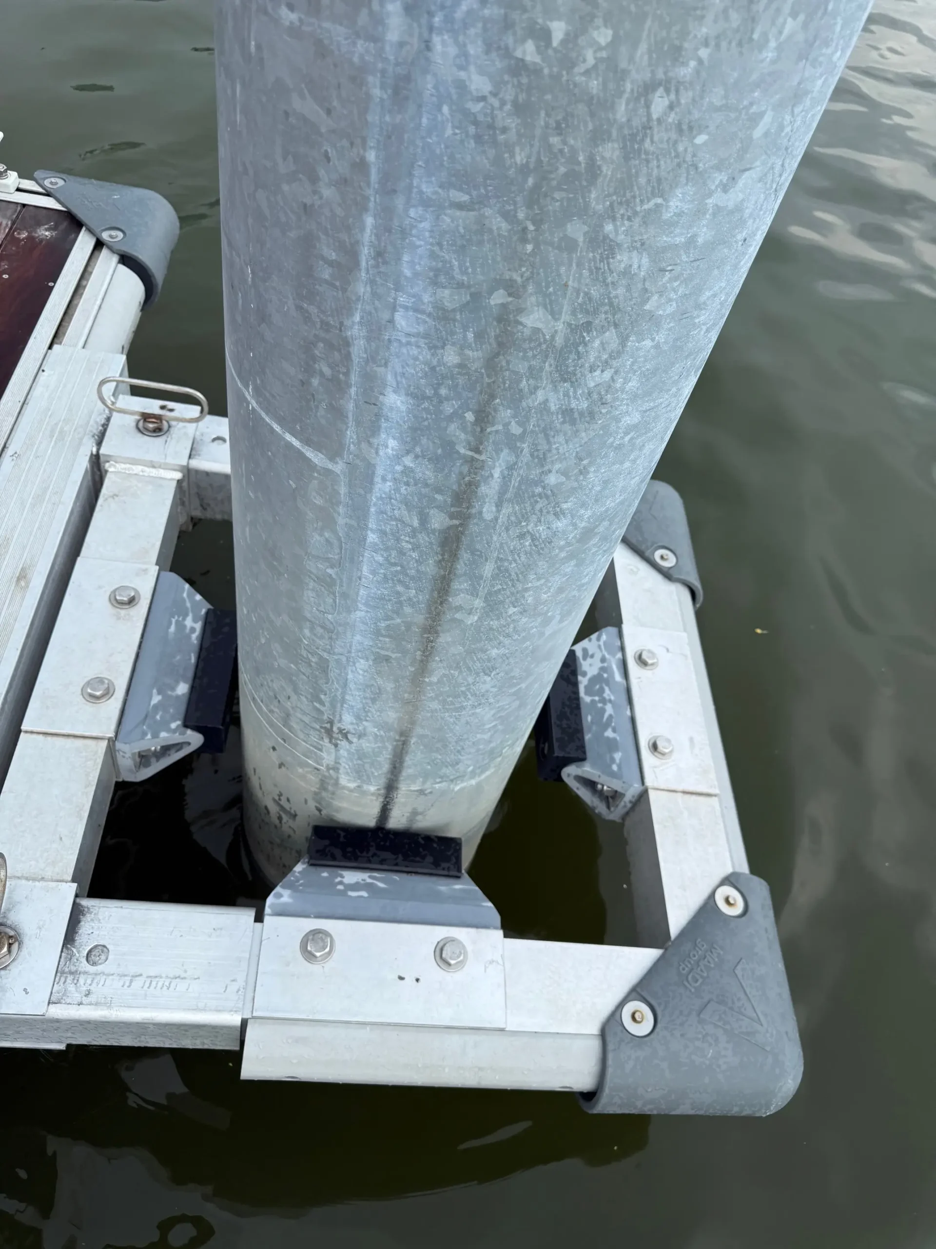 Advanced shock-absorbing pile guide system reducing wave energy transfer on aluminum floating docks.
