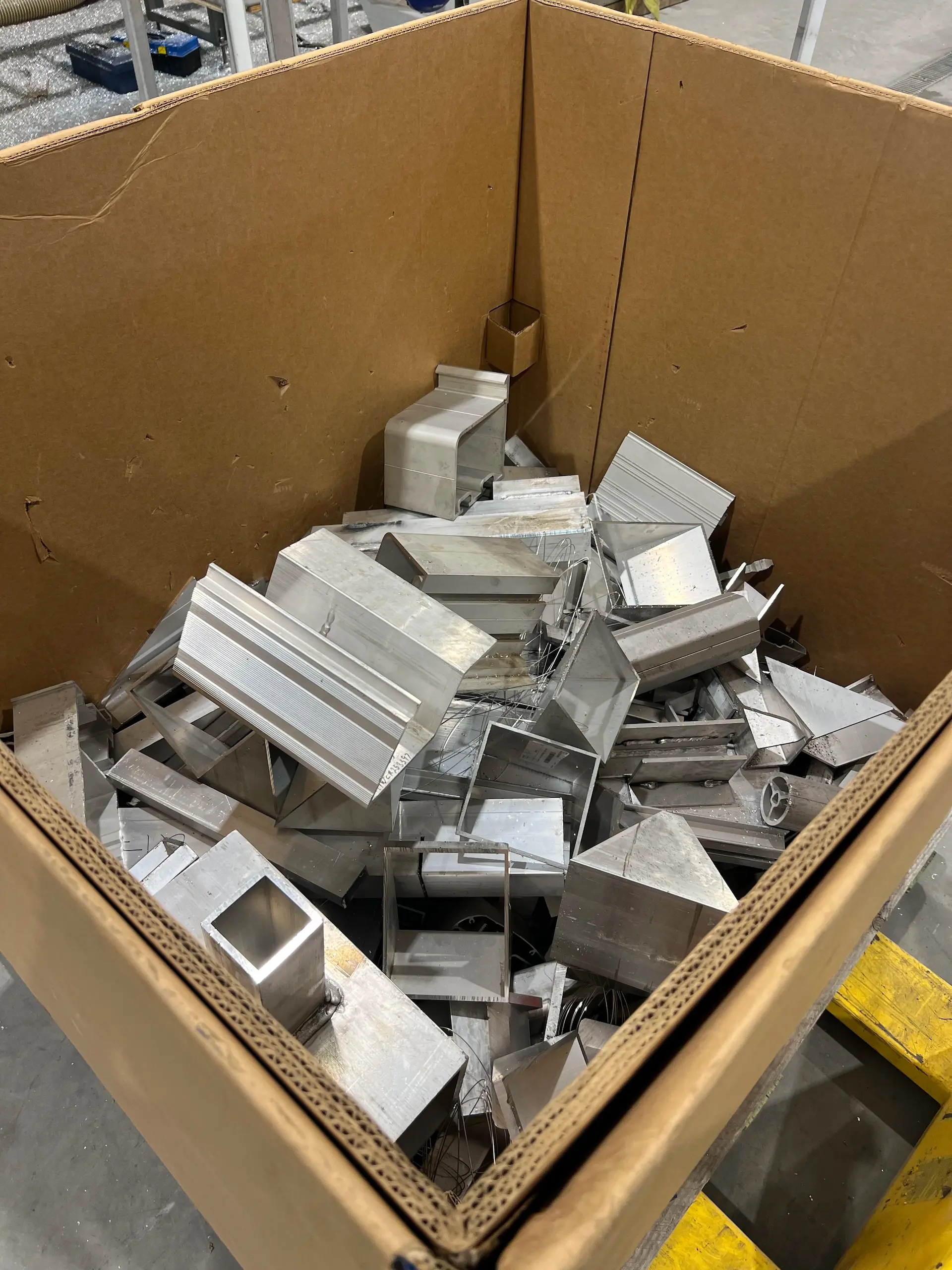 Box of aluminum scraps in MAADI Group’s workshop. Aluminum materials are collected for recycling to minimize waste.
