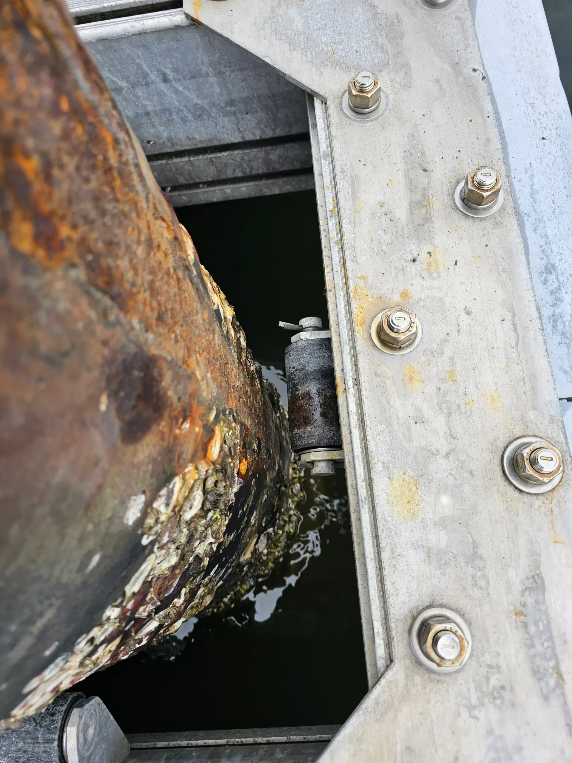 Worn pile-guide rollers with jammed roller after 9 years of prolonged saltwater exposure.